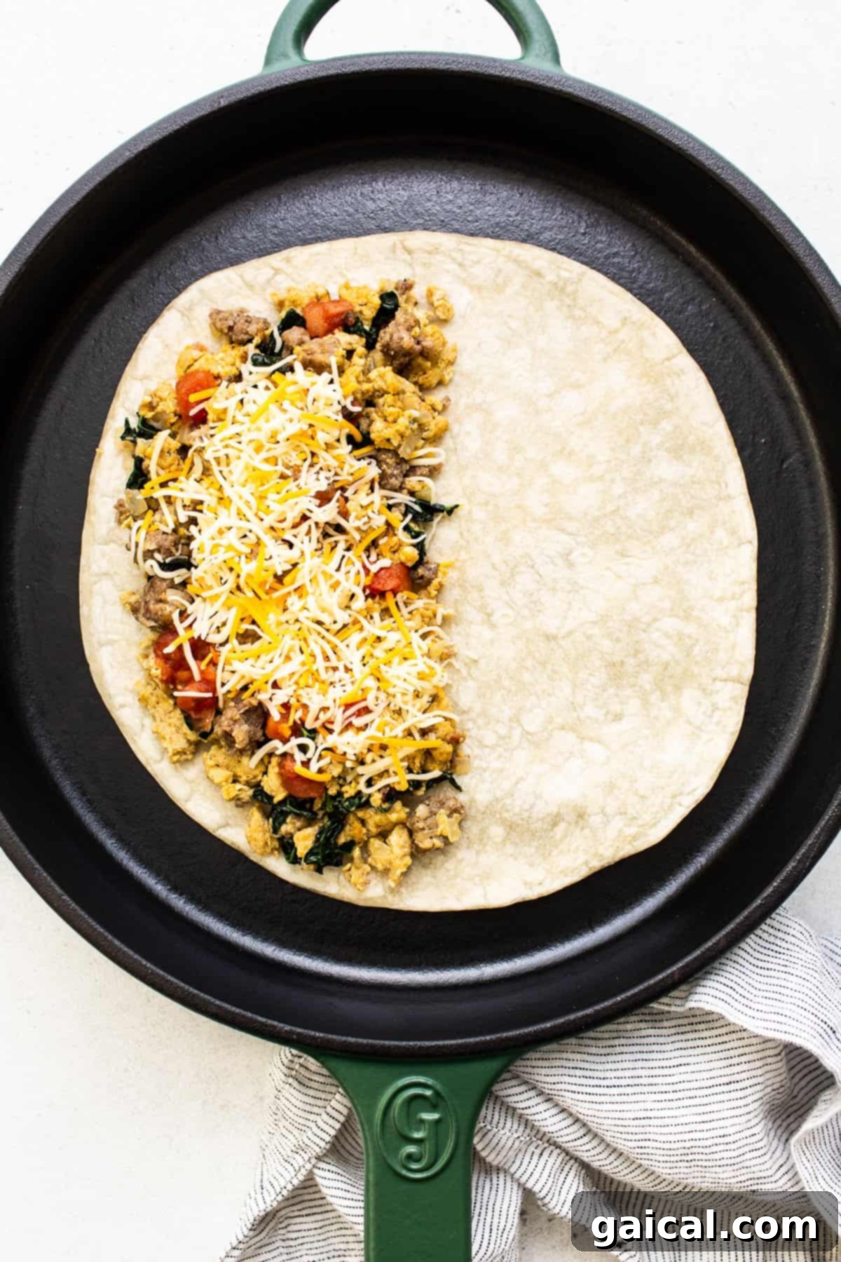 Step-by-Step Guide: Crafting Your Freezer Breakfast Quesadillas A breakfast quesadilla perfectly assembled in a cast iron skillet, ready for cooking.