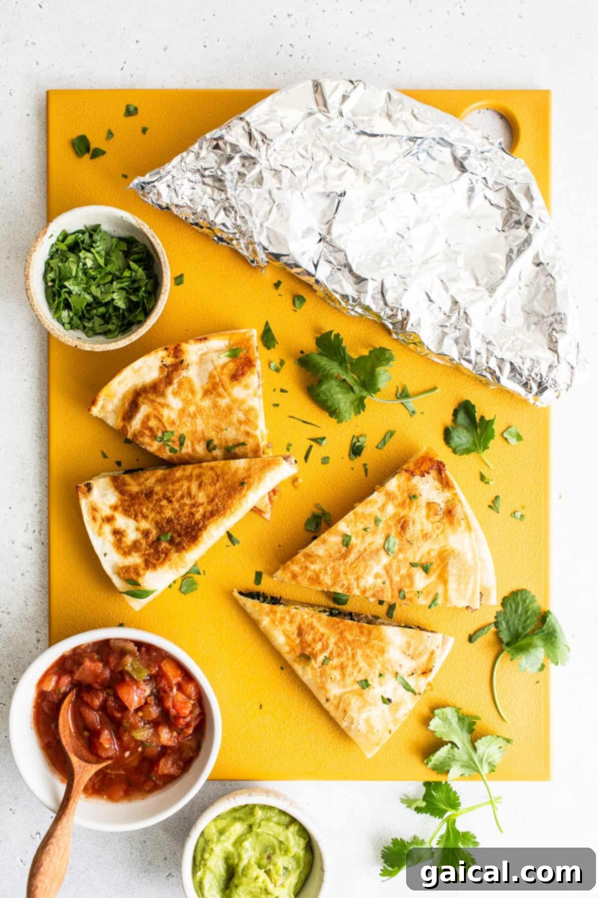 Expert Tips for Perfect Breakfast Quesadillas Slices of make-ahead freezer breakfast quesadillas arranged artfully on a cutting board, ready for serving.
