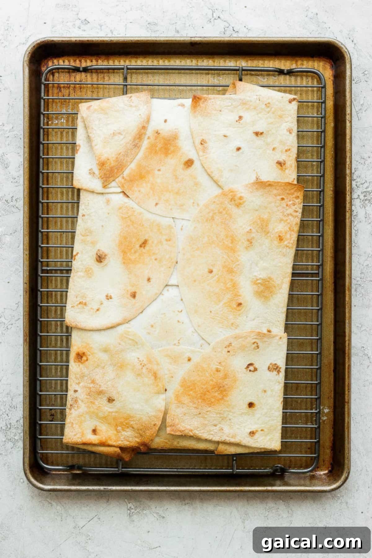 Sheet Pan Quesadilla Party 6 Golden brown and crispy sheet pan quesadillas fresh out of the oven, resting on a baking sheet.