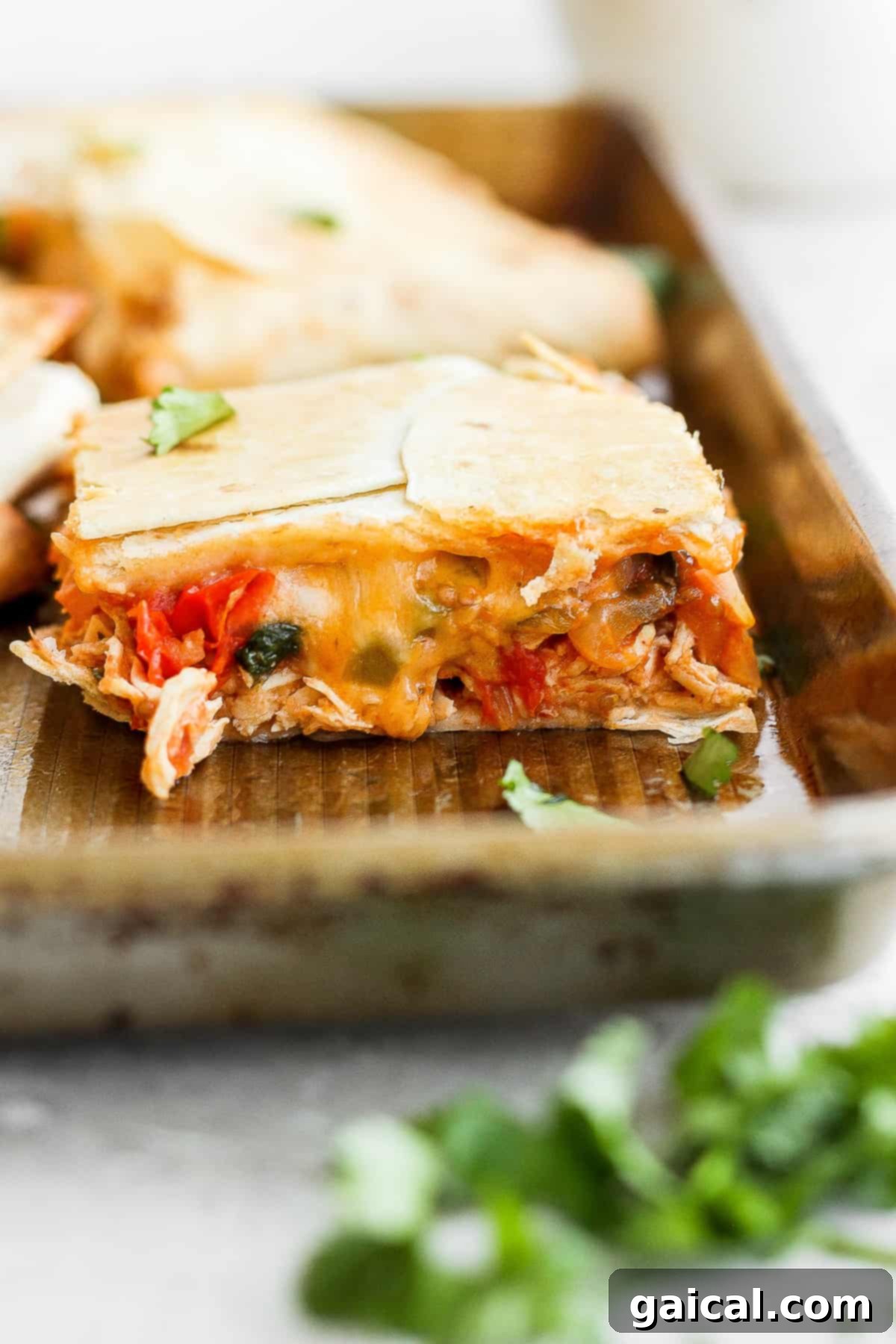 Sheet Pan Quesadilla Party 7 Close-up of a sheet pan quesadilla with savory filling and melted cheese visible before baking.