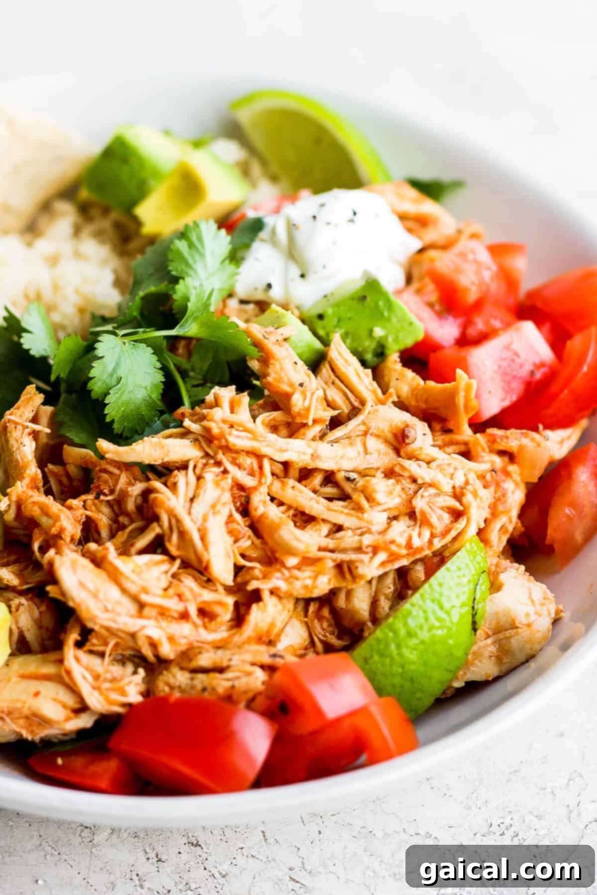 Serving chicken tinga in a bowl with toppings. Chicken tinga in a bowl.