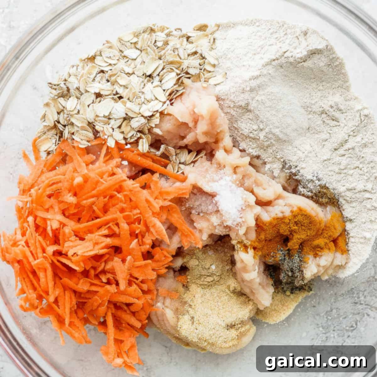 All of the ingredients for these chicken meatballs in a mixing bowl.