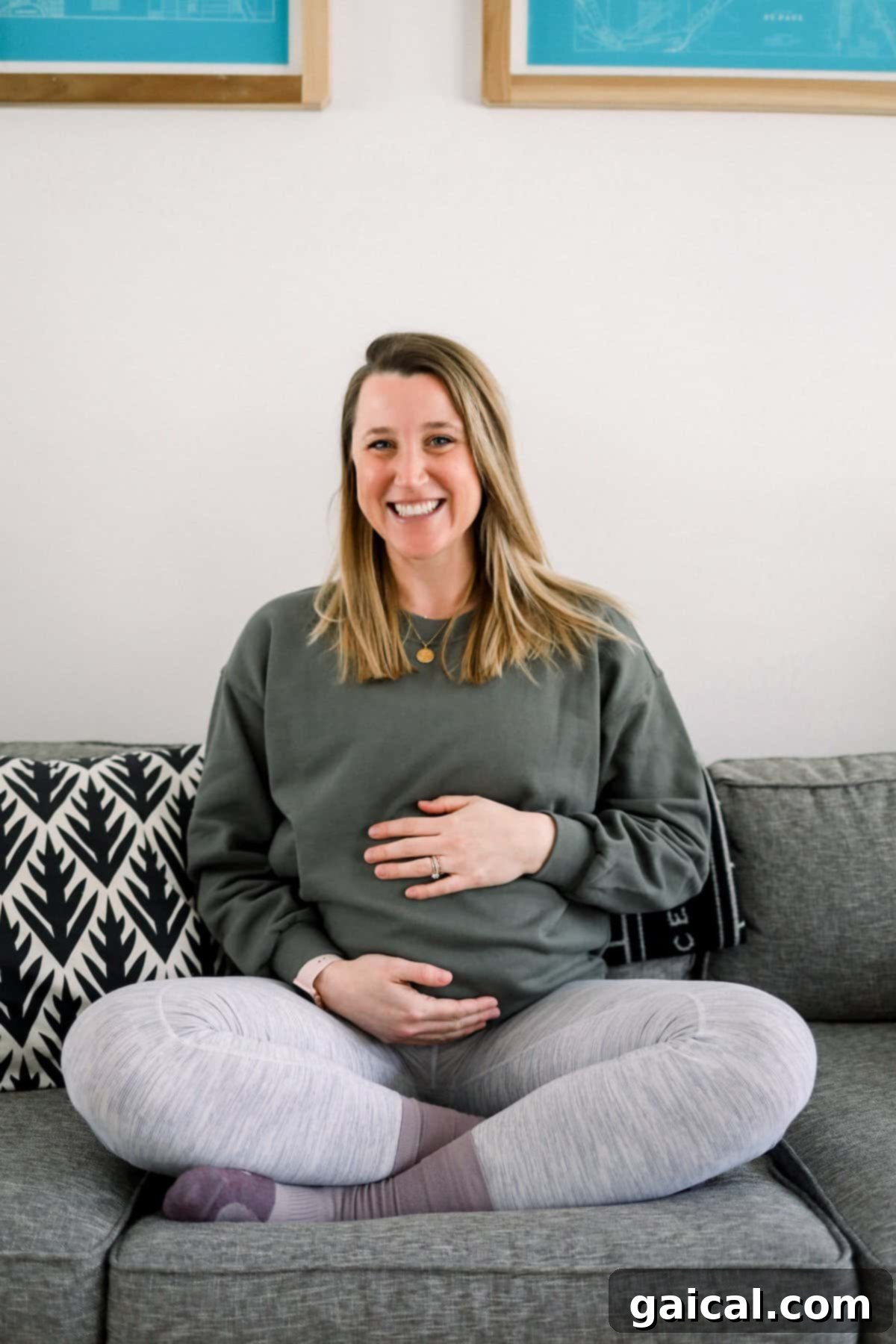 Lululemon Cropped Crew for Pregnancy Pregnant woman relaxing on a couch, wearing a comfortable Lululemon Perfectly Oversized Cropped Crew sweatshirt.