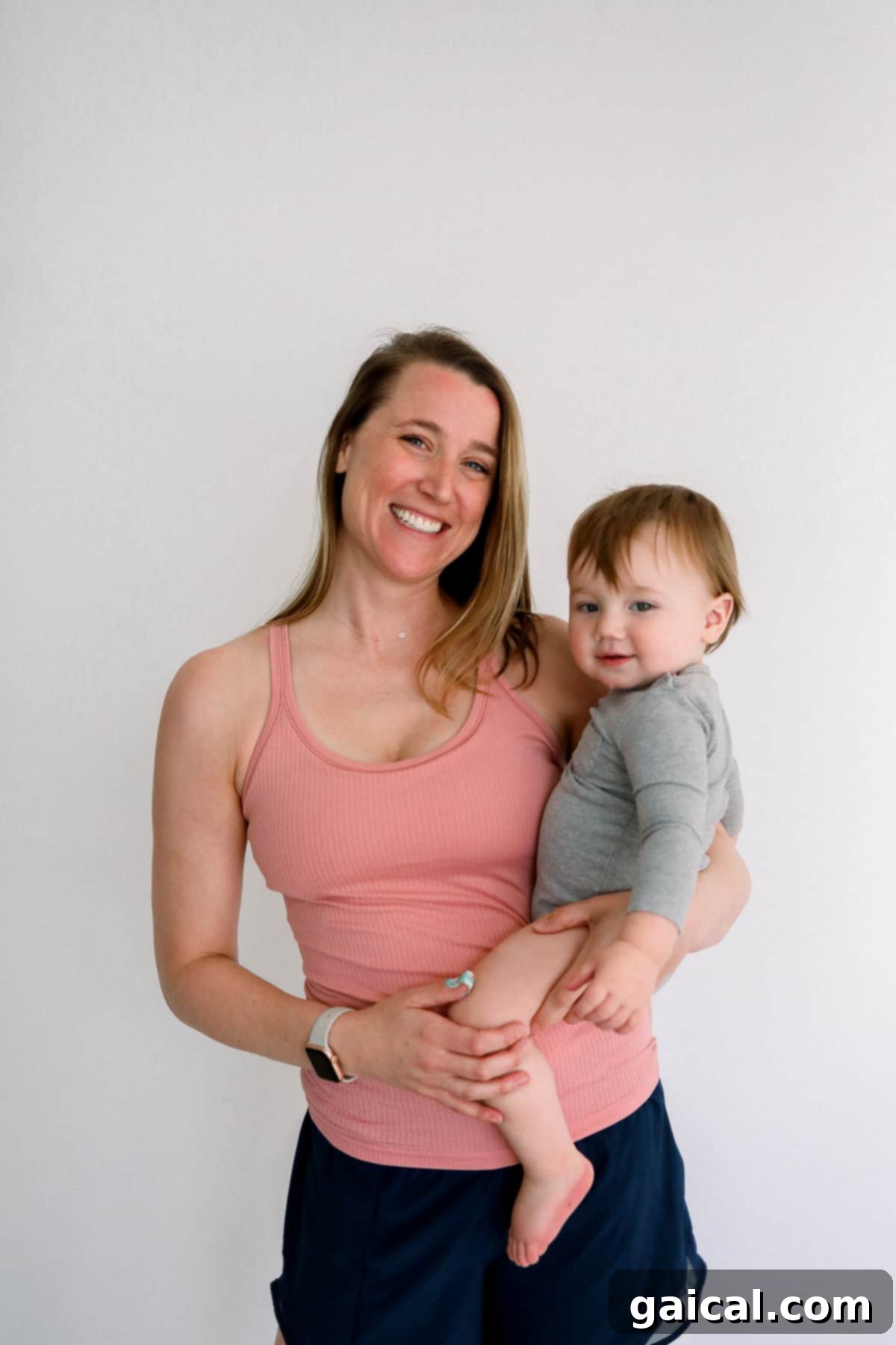 Lululemon Ebb to Street Tank for Nursing Woman gently holding a baby, wearing a Lululemon Ebb to Street Tank, perfect for nursing and postpartum comfort.
