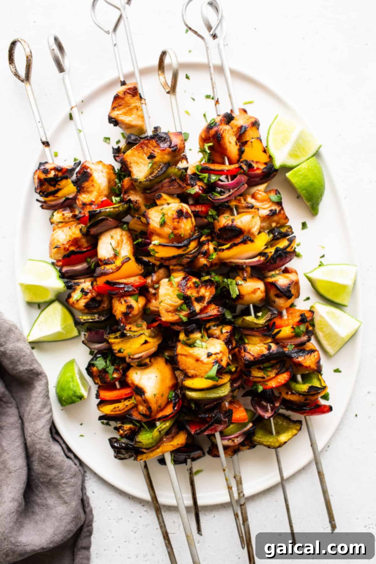 Kaleidoscope Chicken Skewers 2 Grilled chicken kabobs on a serving platter, showcasing vibrant colors.