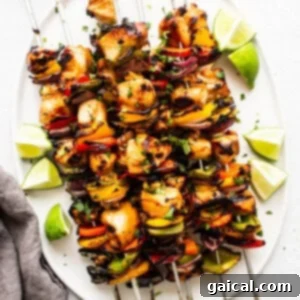 Kaleidoscope Chicken Skewers 14 Cooked chicken kabobs resting on a plate after being removed from the grill, ready to be served.