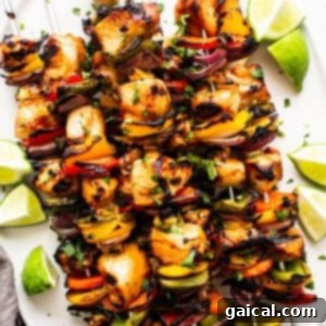 Kaleidoscope Chicken Skewers 10 Close-up image of cooked chicken kabobs on a plate, ready to be served.