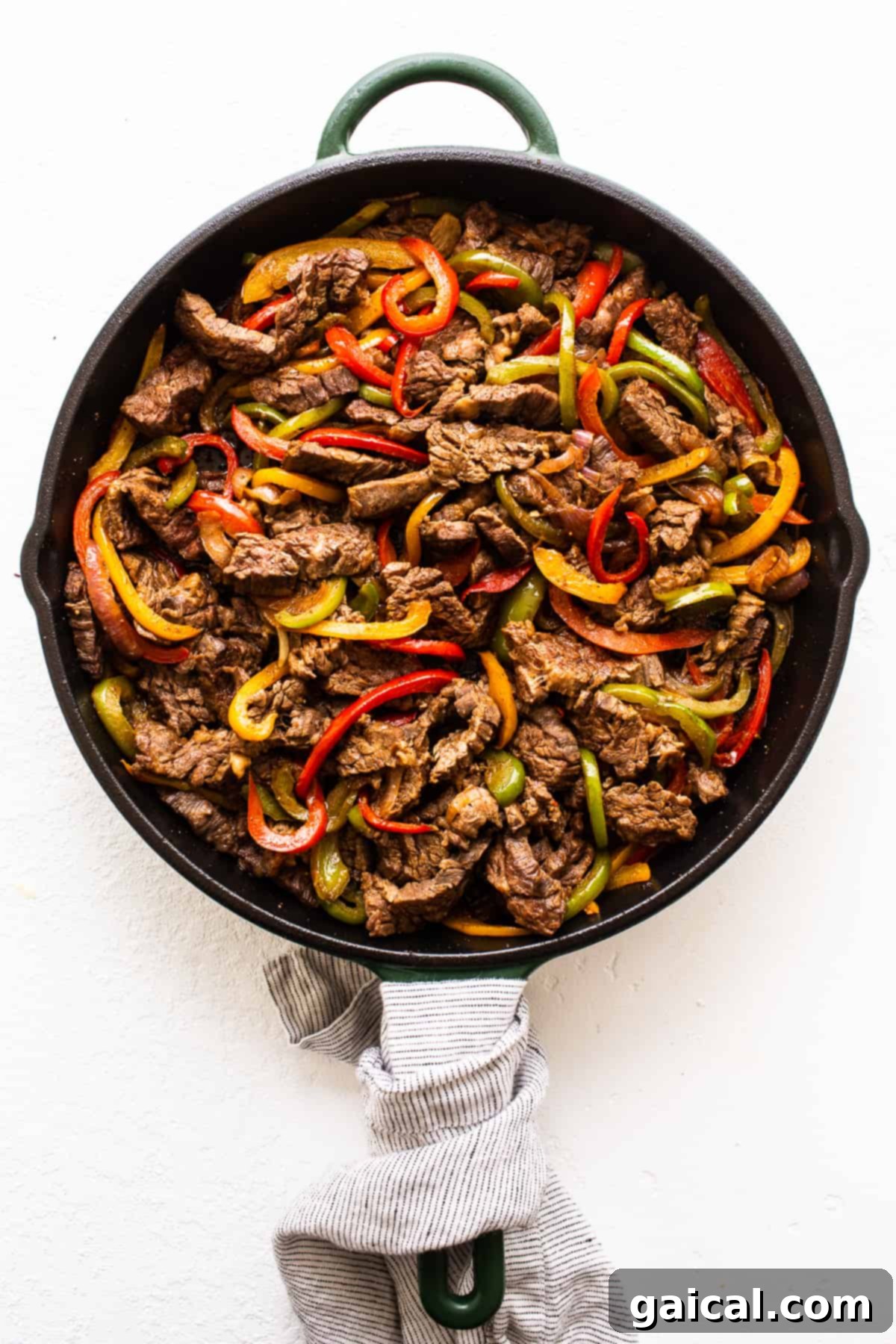 Sizzling Steak Fajitas 4 Steak fajitas and fajita veggies sizzling in a cast iron skillet.