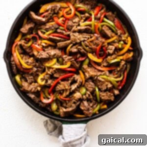 Sizzling Steak Fajitas 11 Steak and peppers cooking together in a skillet.