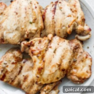 Grilled chicken thighs on a plate.