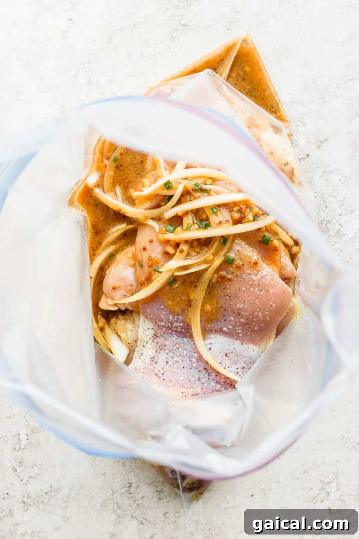 Chicken thighs and honey mustard marinade in a gallon-size bag.