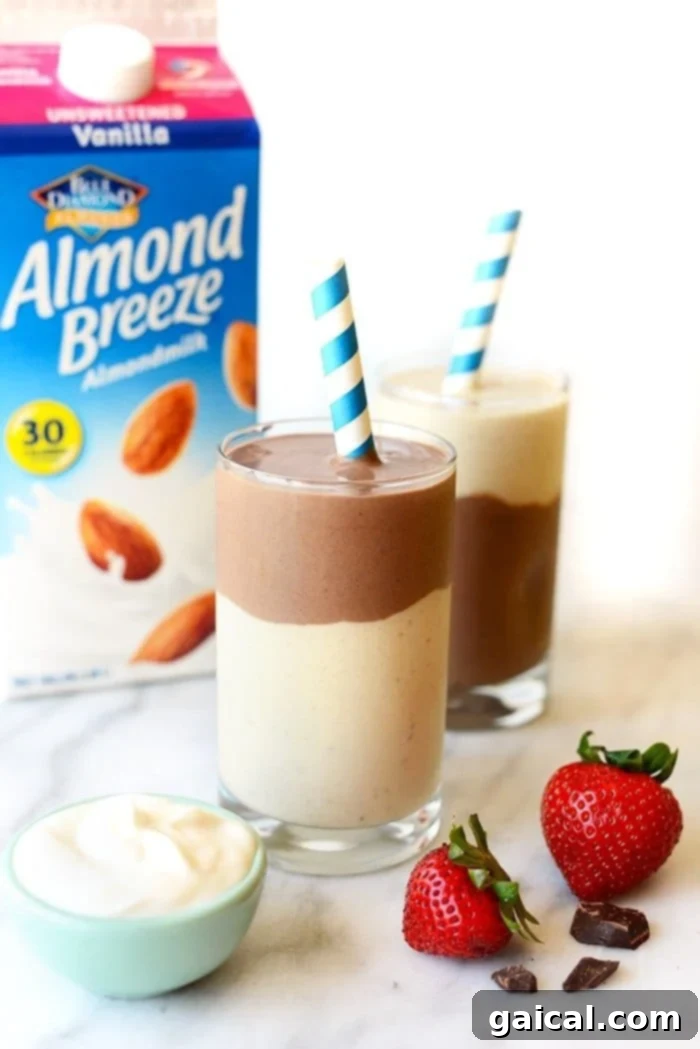Chocolate Banana Protein Smoothie for Recovery Layered chocolate banana smoothie with an Almond Breeze carton in the background, showcasing its rich texture.