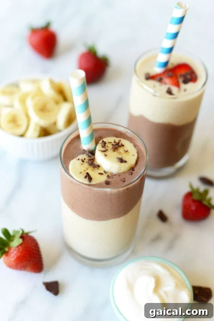 Indulgent Chocolate Banana Smoothie Thick chocolate banana smoothie with a straw and fresh banana slices, ready to be served.