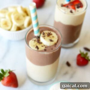 Banana chocolate protein smoothie ready to be served in a glass.
