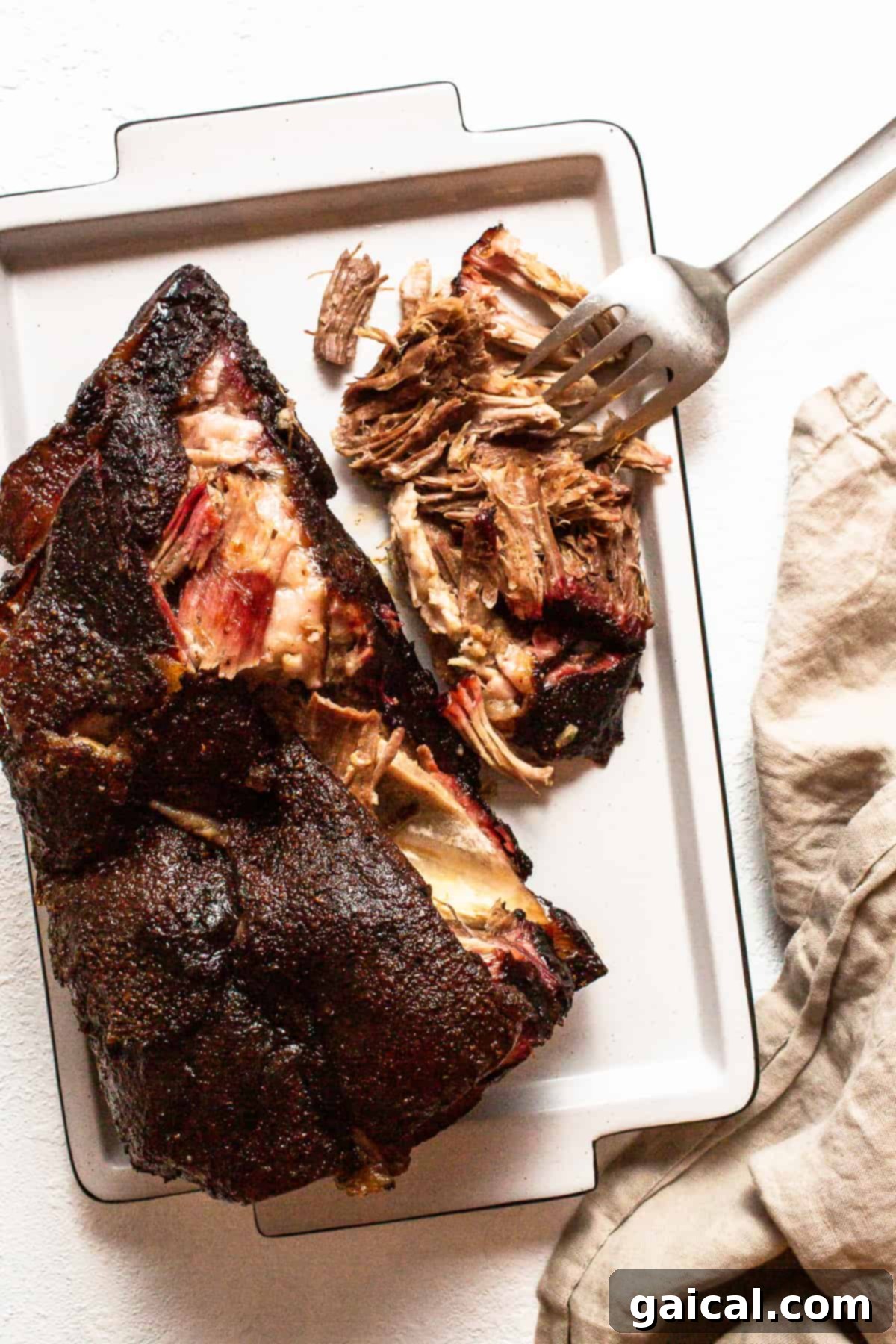Finished pork shoulder on a tray after resting.