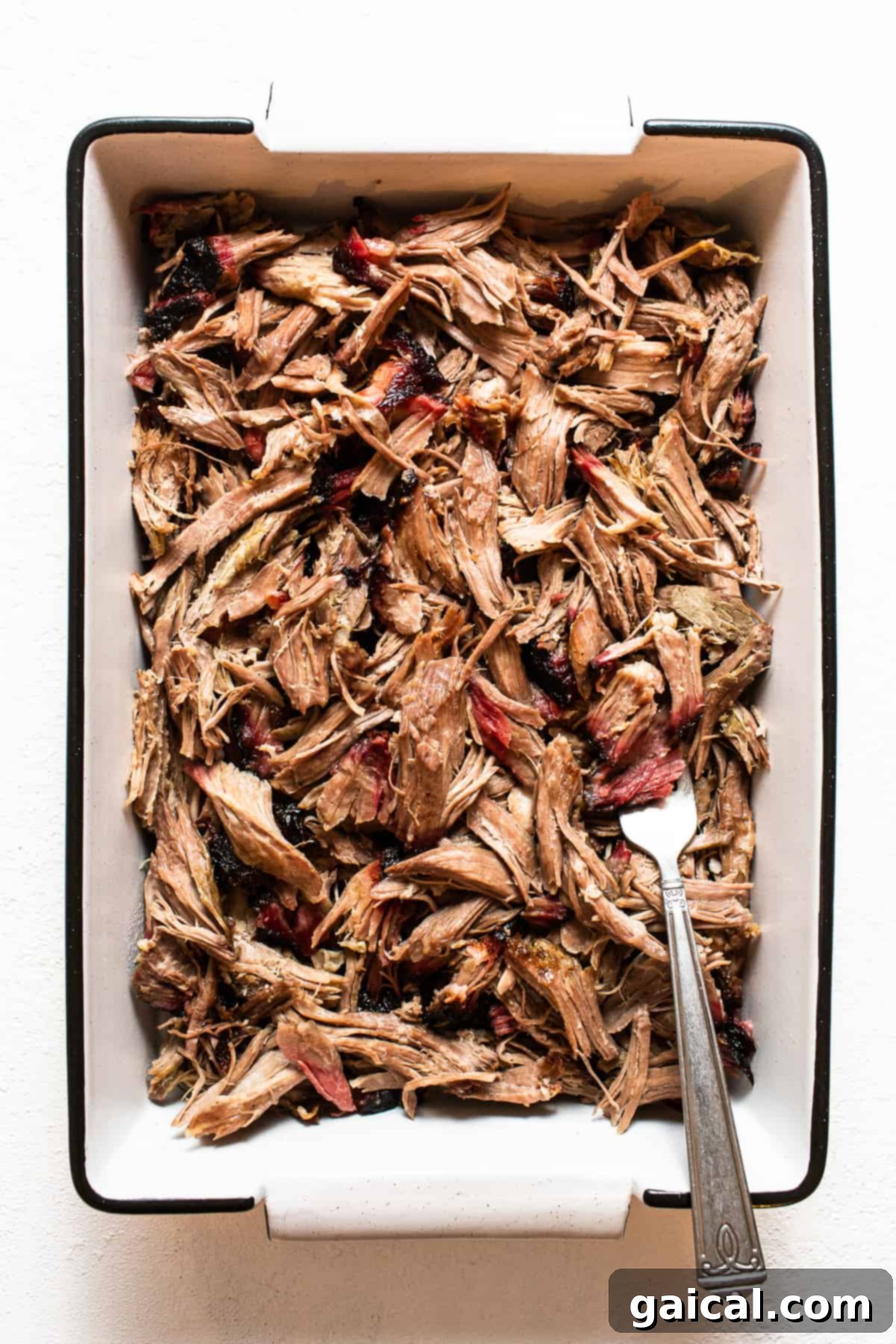 Shredded pork shoulder in a serving dish, ready to be enjoyed.