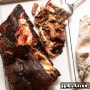 Finished pork shoulder on a tray after resting.
