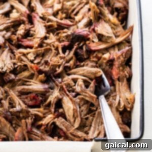 Shredded smoked pork shoulder in a tray.