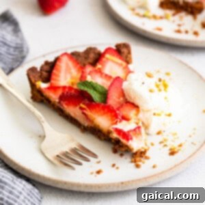 A slice of strawberry pie with whipped cream and a fork.