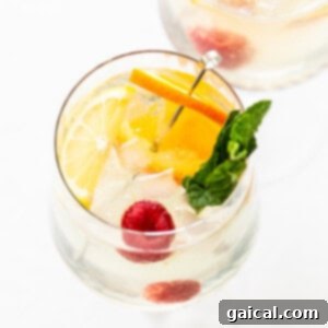 A pristine white wine spritzer in a classic wine glass, ready to be enjoyed.