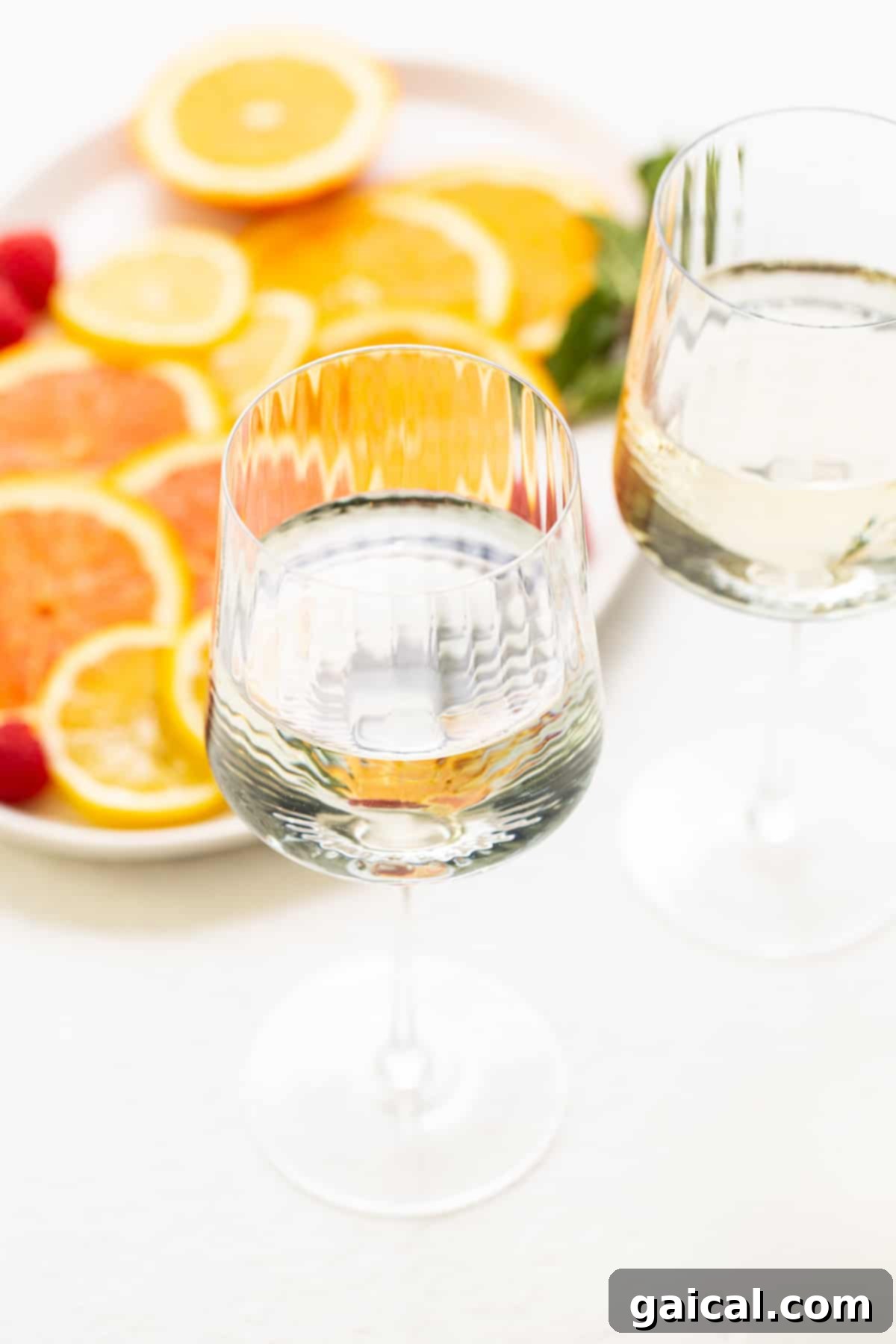 Crisp White Wine Refresher 4 A pristine glass filled with golden white wine, reflecting the light, signifying the quality base for a perfect spritzer.