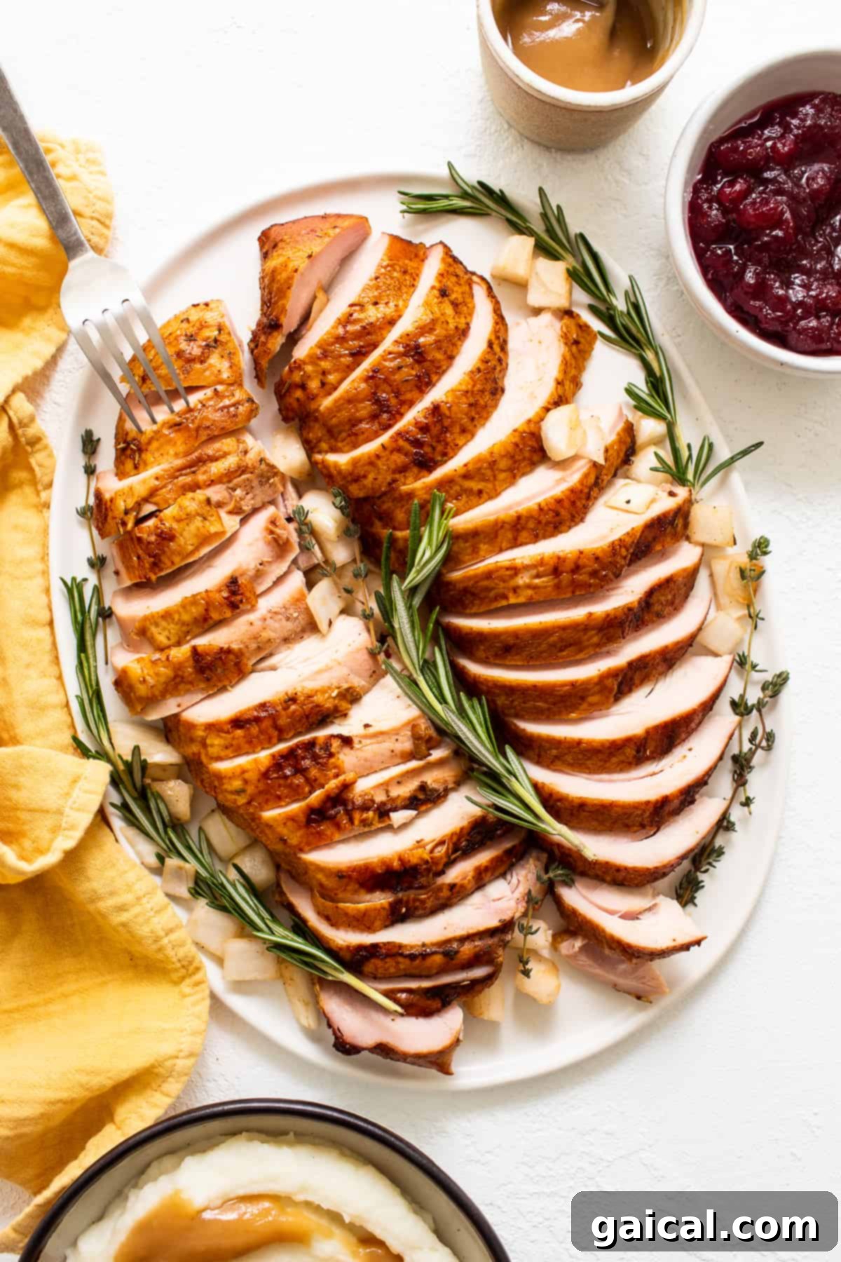 Beautifully sliced smoked turkey breast arranged artfully on a serving plate.
