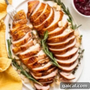 Smoked turkey breast beautifully sliced on a cutting board, ready to serve.
