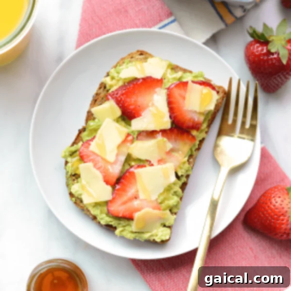 A plate of toast with strawberries and guacamole.