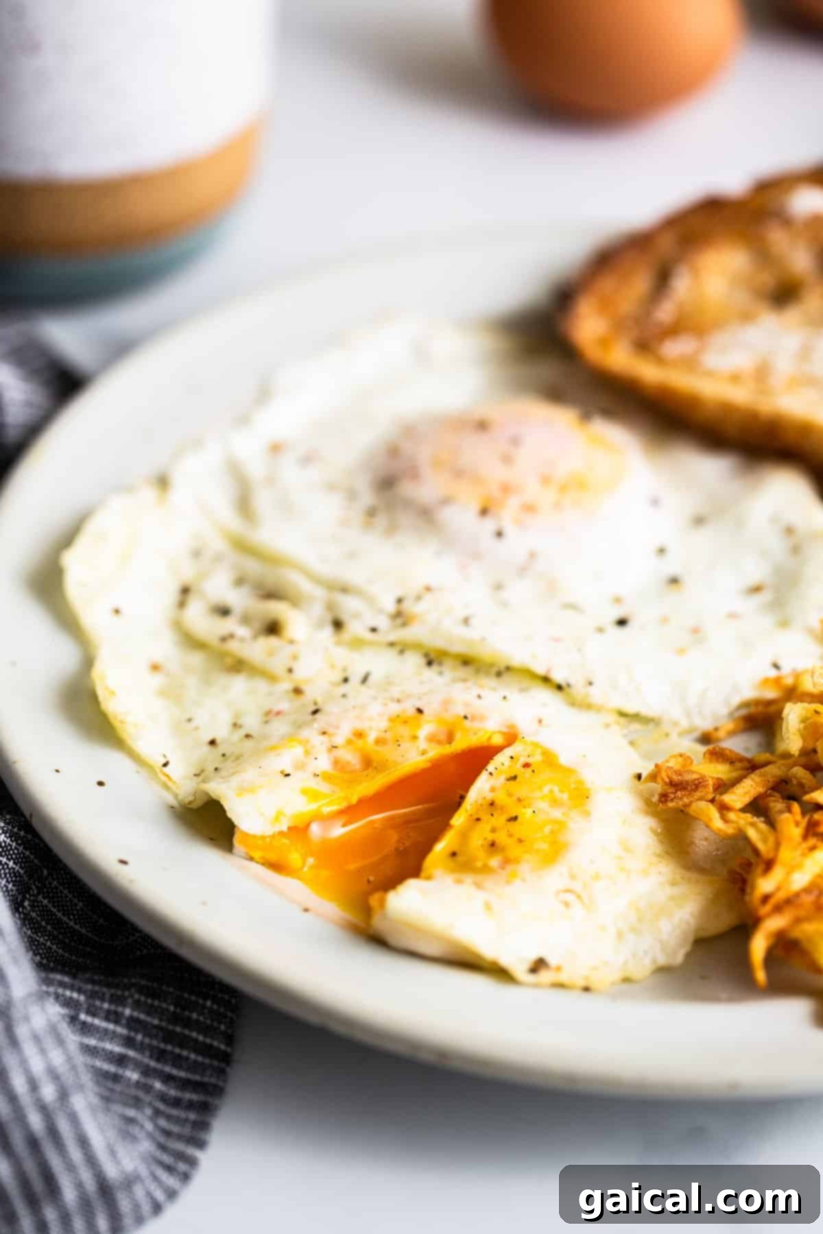 Over medium eggs ready to be served on a plate.