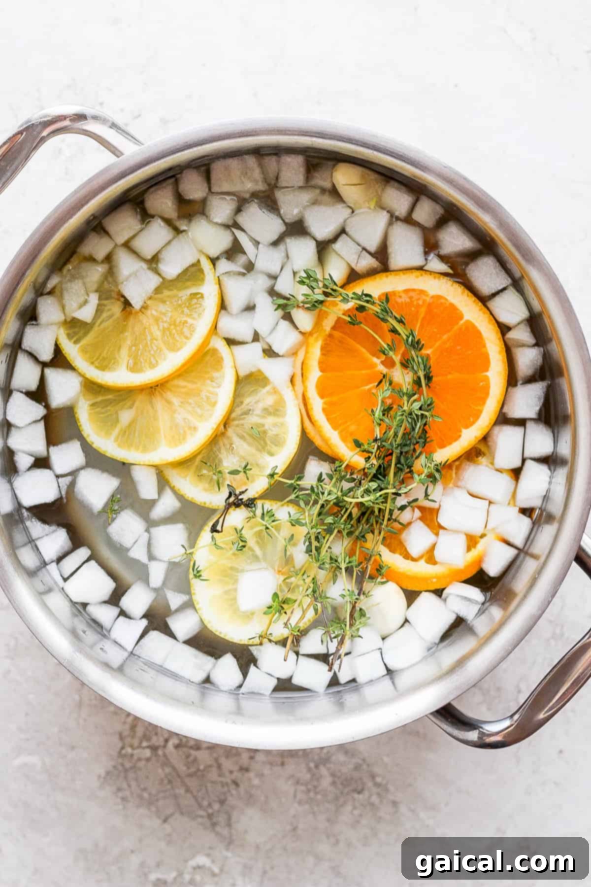 This simple, classic whole chicken brine gives you the juiciest, most delicious whole chicken you’ve ever tasted. A large pot filled with chicken brine, showcasing the aromatic ingredients and the submerged whole chicken.