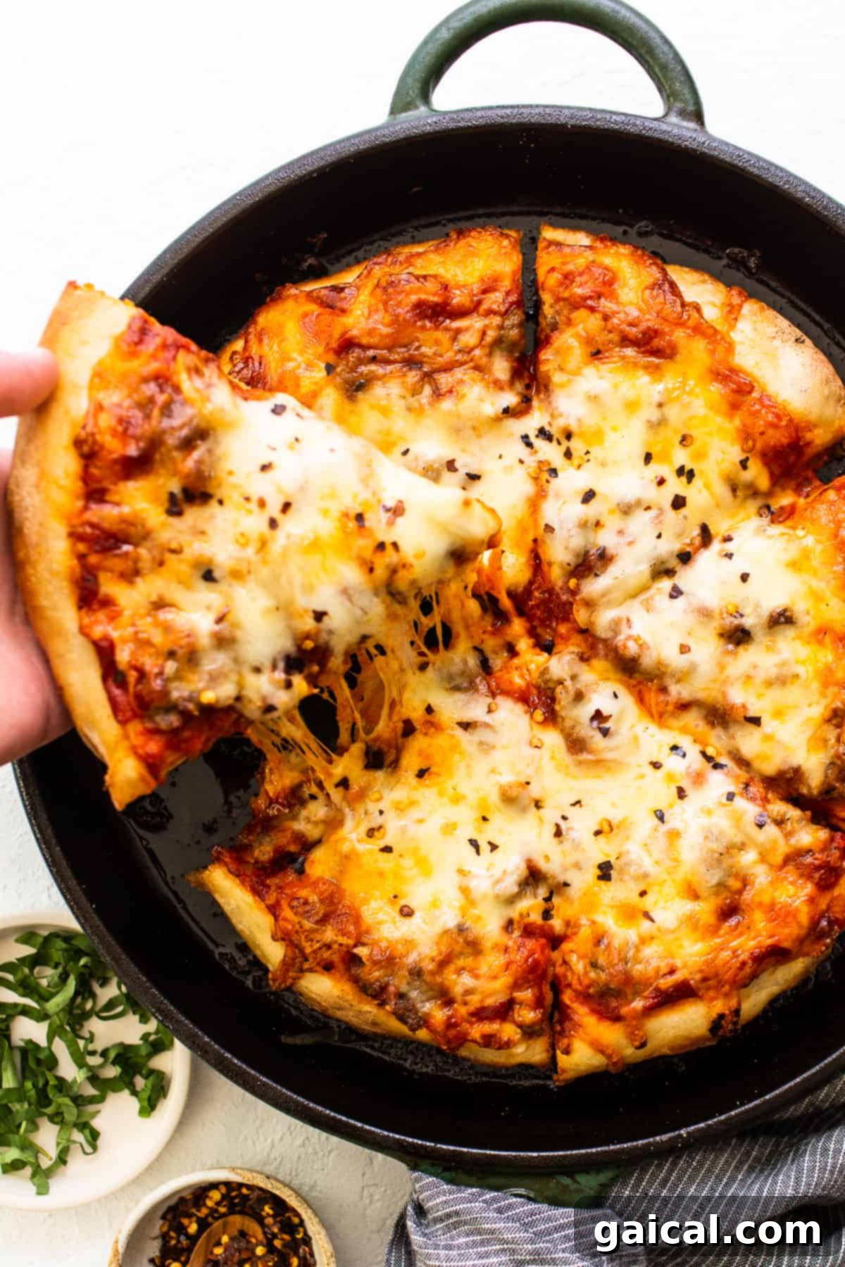 Cast Iron Pizza: Crispy Crust Perfection from Oven or Grill pizza in cast iron pan, showcasing a golden, crispy crust.