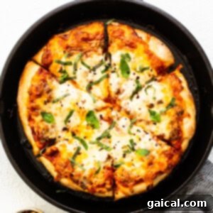 pizza in cast iron, highlighting the delicious toppings and golden crust.