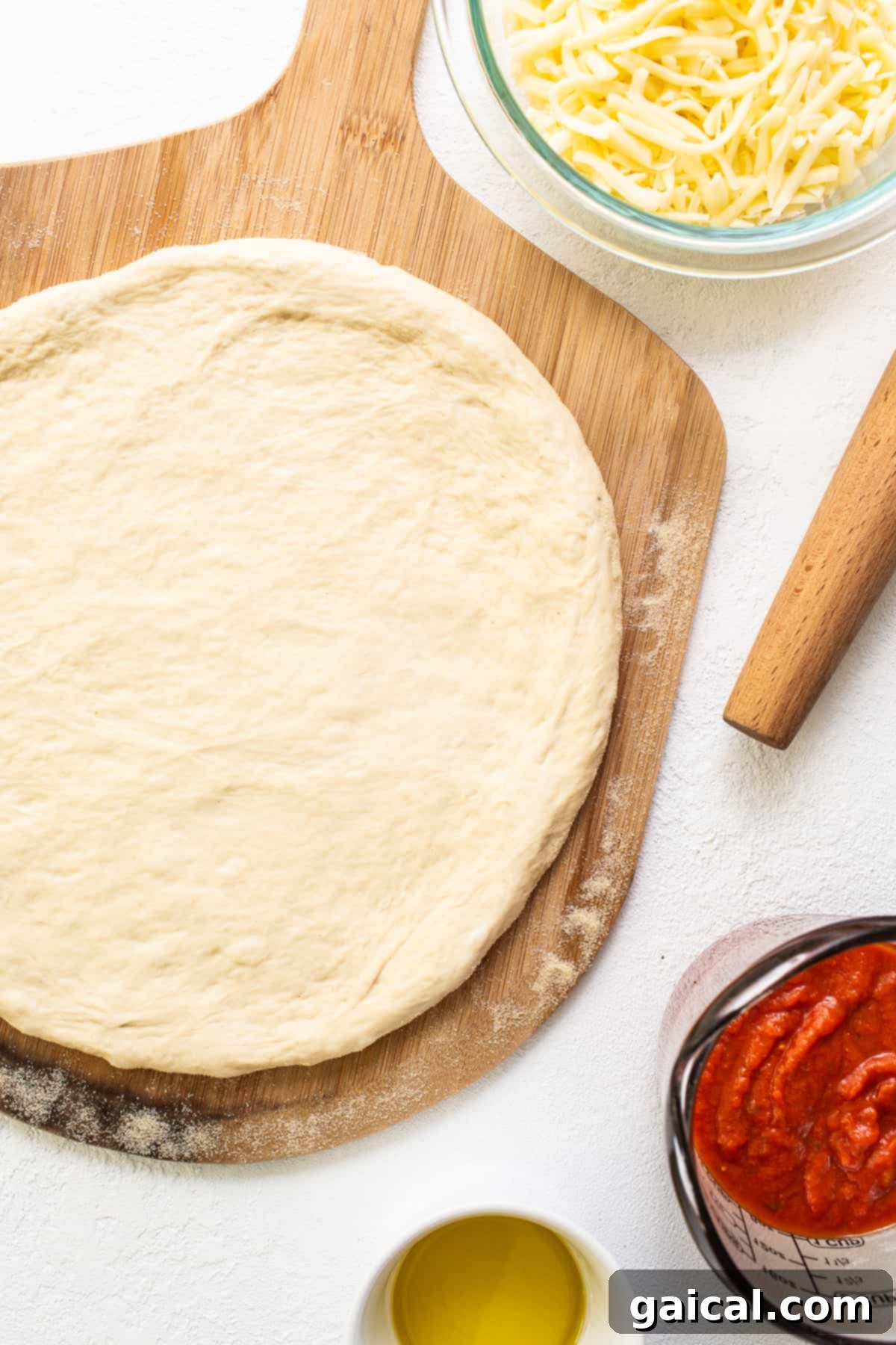 Crispy Cast Iron Pizza Crust pizza crust on cutting board, showing its perfectly browned texture.