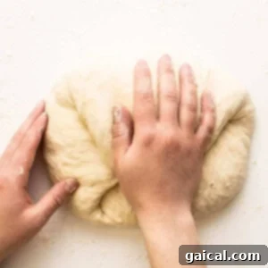 Cast Iron Pizza Oven and Grill 3 kneading pizza dough for a homemade pizza base.