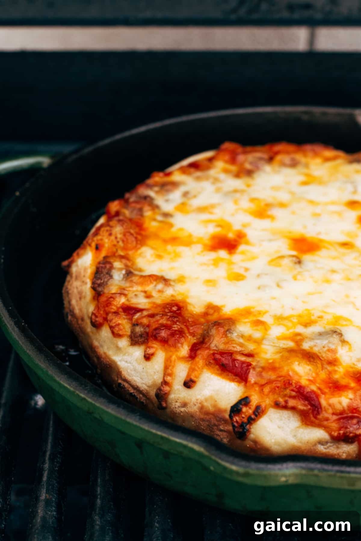 Cast Iron Pizza Oven and Grill 4 a perfectly baked cast iron pizza with melted cheese and golden crust.