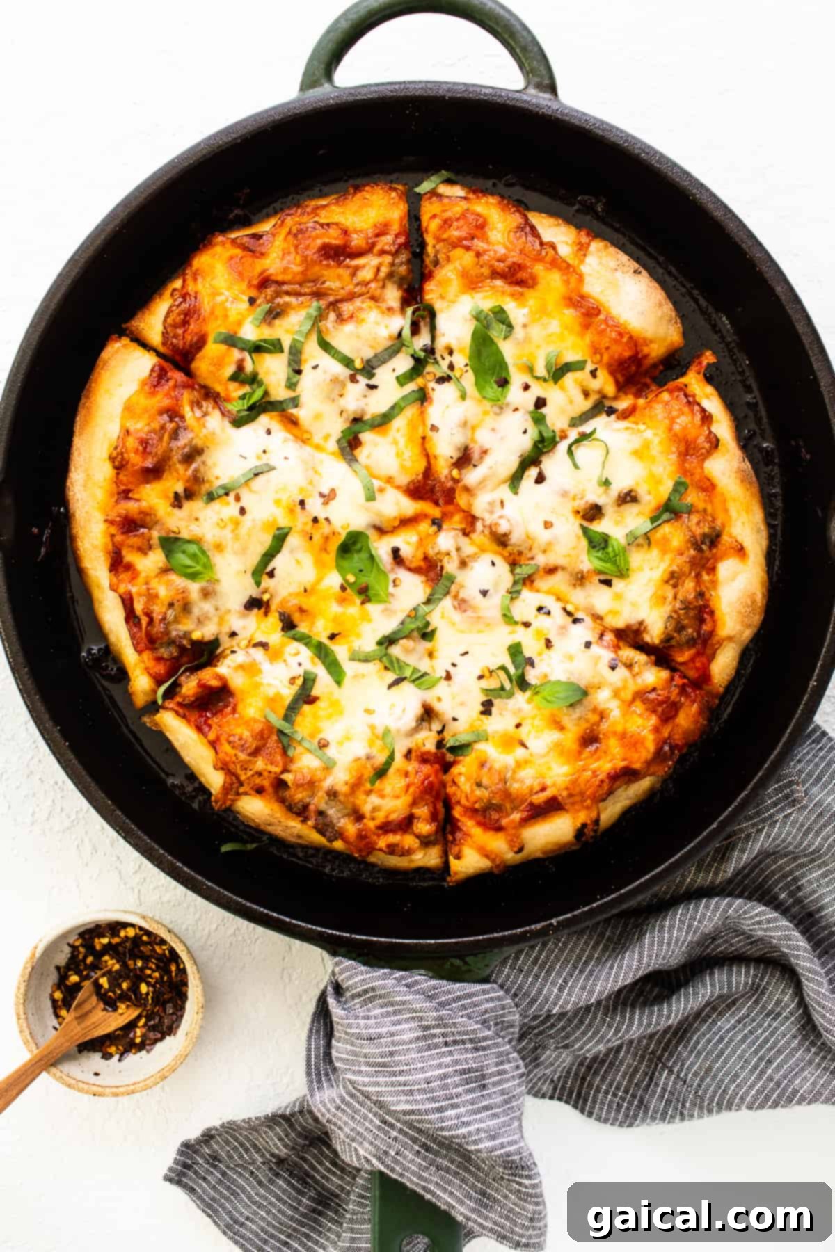 Garnished Cast Iron Pizza cast iron pizza with fresh basil garnish.