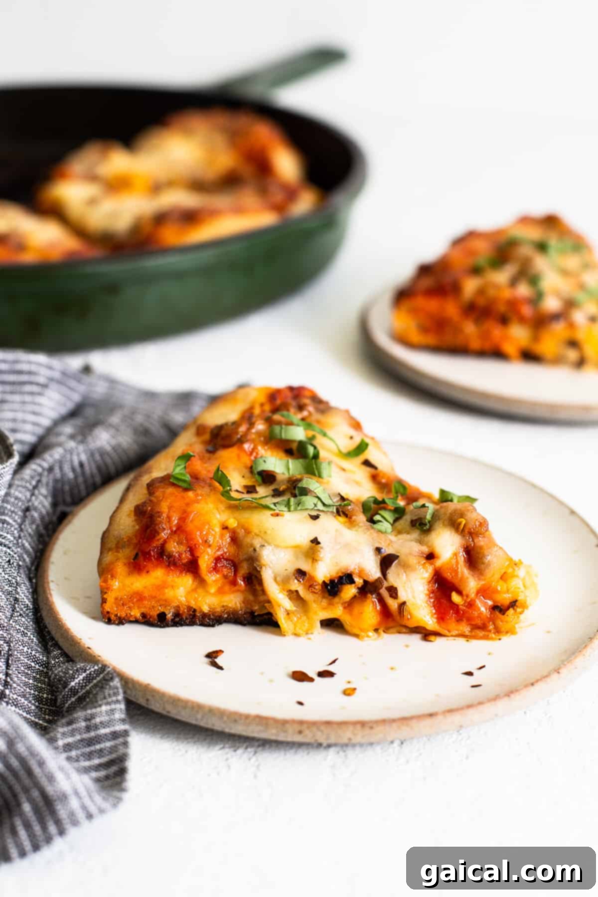 Served Cast Iron Pizza cast iron pizza slice on a plate, ready to be eaten.