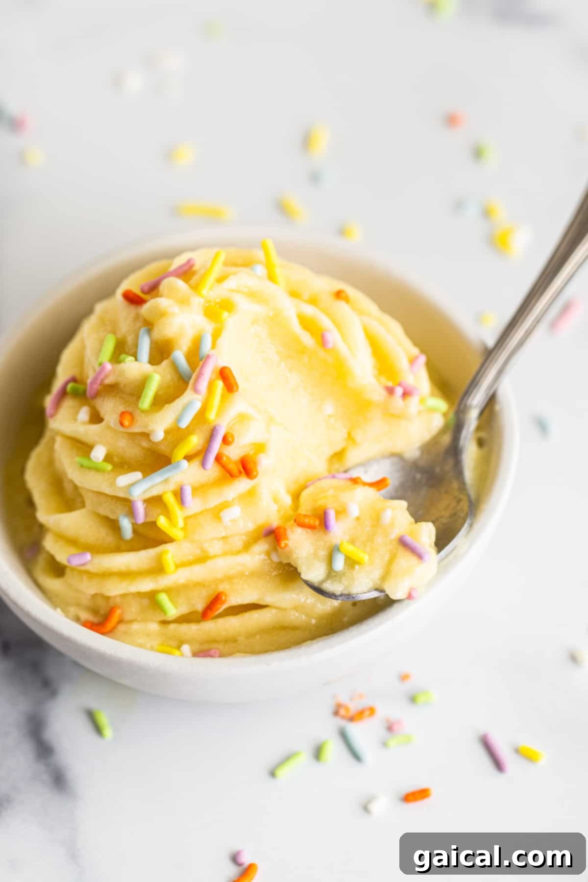 Dole Whip Served in a Bowl A beautifully swirled Dole Whip in a bowl, topped with a spoon, ready to be enjoyed. The texture is perfectly creamy and inviting.