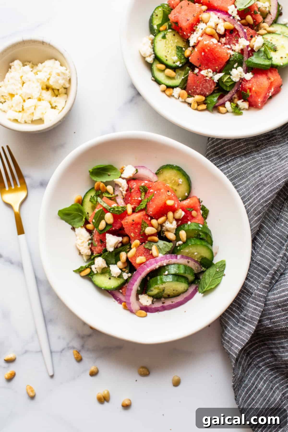 Close-up of a bowl of watermelon salad, showing texture and ingredients.