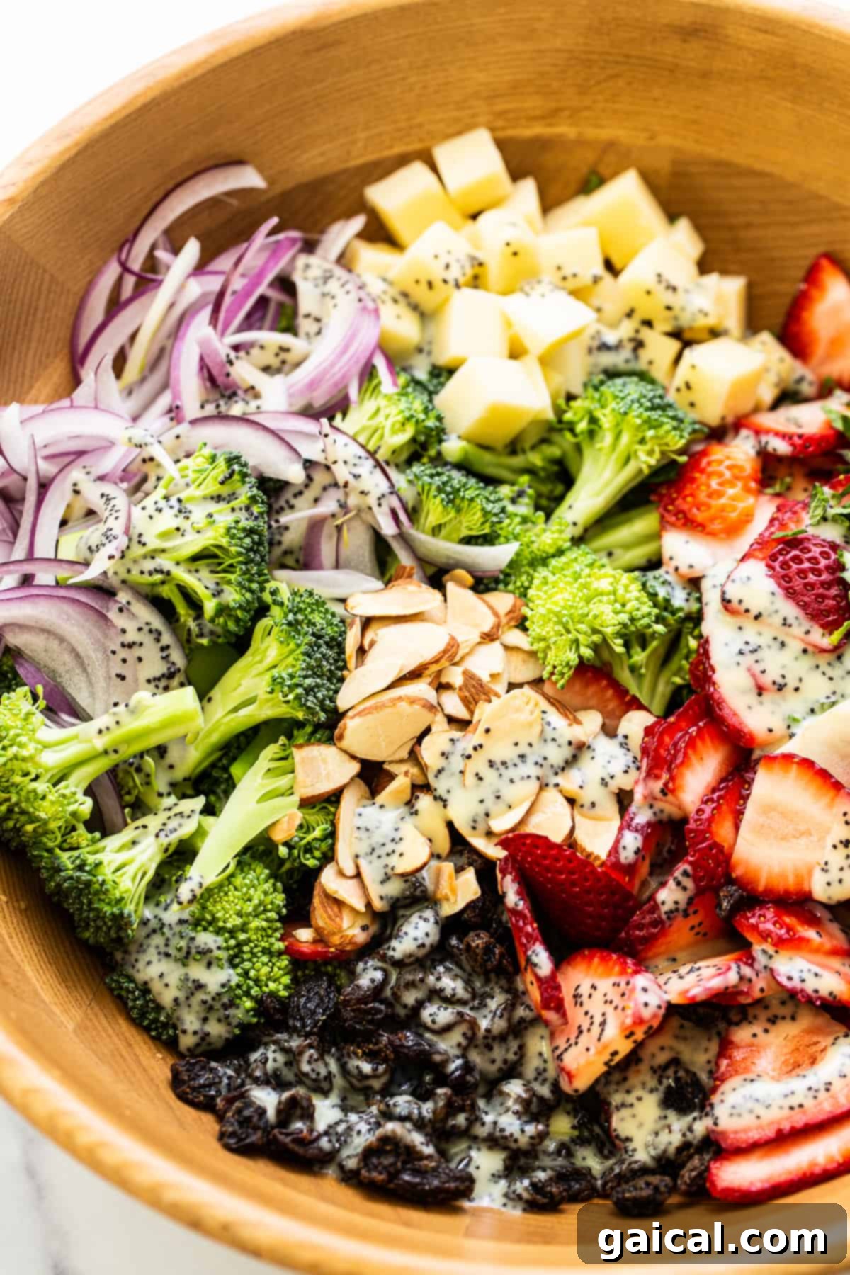 Strawberry Broccoli Salad with Poppy Seed Dressing Strawberry broccoli salad topped with a generous drizzle of poppy seed dressing, ready to be served.
