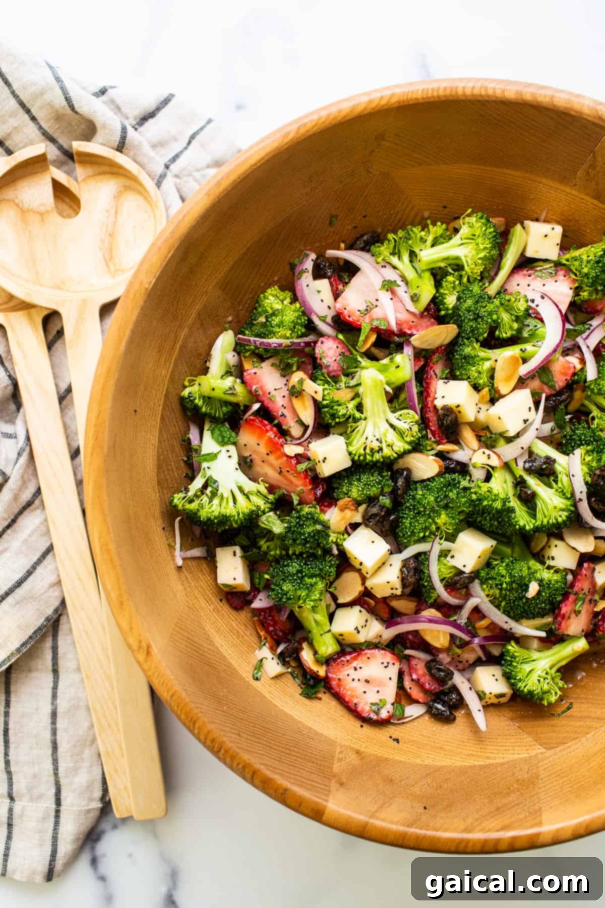 Fresh and Flavorful Strawberry Broccoli Salad A beautifully presented strawberry broccoli salad in a rustic wooden bowl, ready for serving.