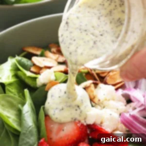 Vibrant Strawberry Broccoli Salad with Poppy Seed Vinaigrette 2 Close-up of poppy seed dressing being poured over a fresh green salad.