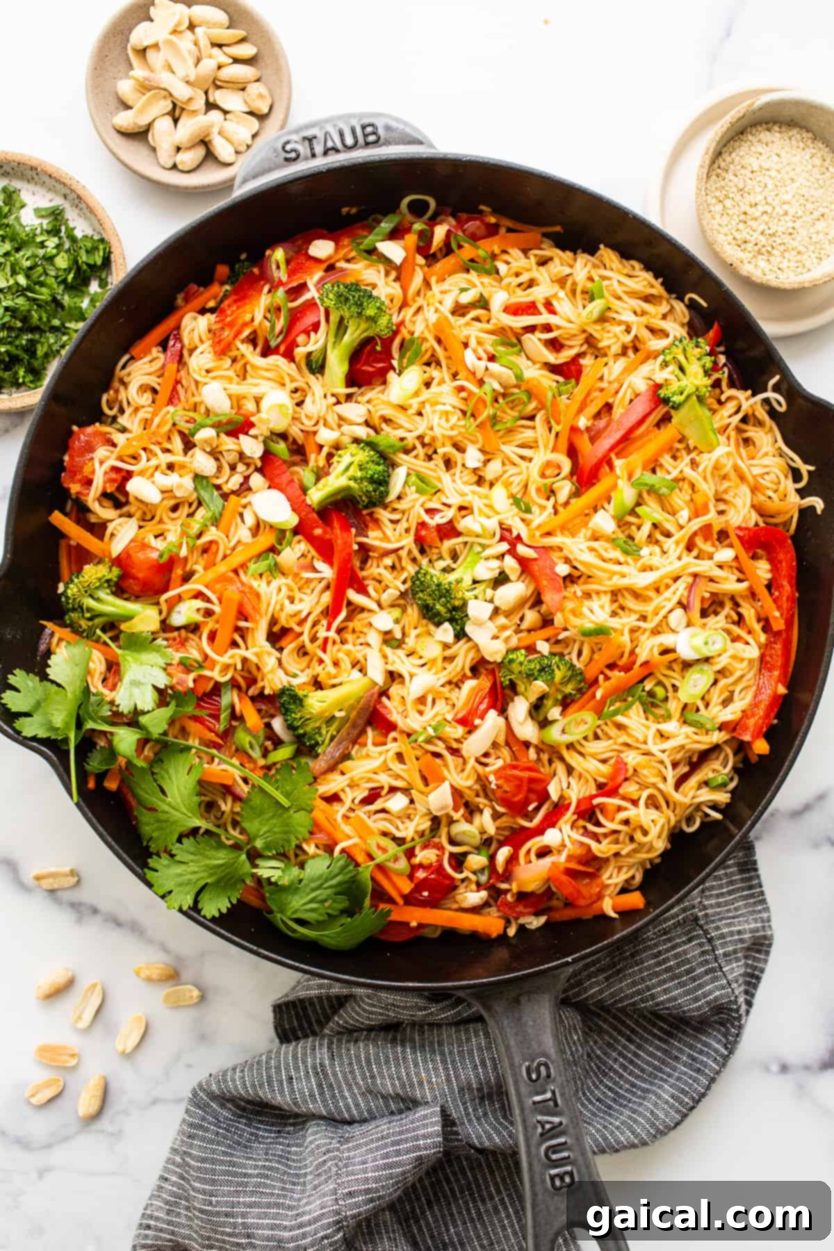 Delicious Peanut Noodles: A Perfect Weeknight Meal A close-up of colorful peanut noodles in a cast iron skillet, garnished with fresh cilantro and crushed peanuts.
