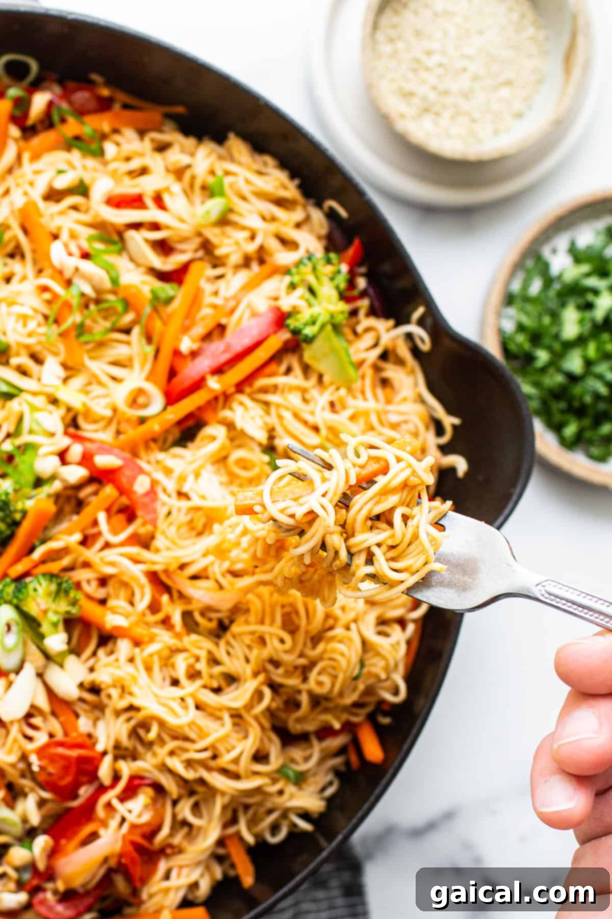 Ready-to-Eat Sesame Peanut Noodles A serving of sesame peanut noodles with vibrant vegetables and garnishes in a shallow dish, ready to be enjoyed.