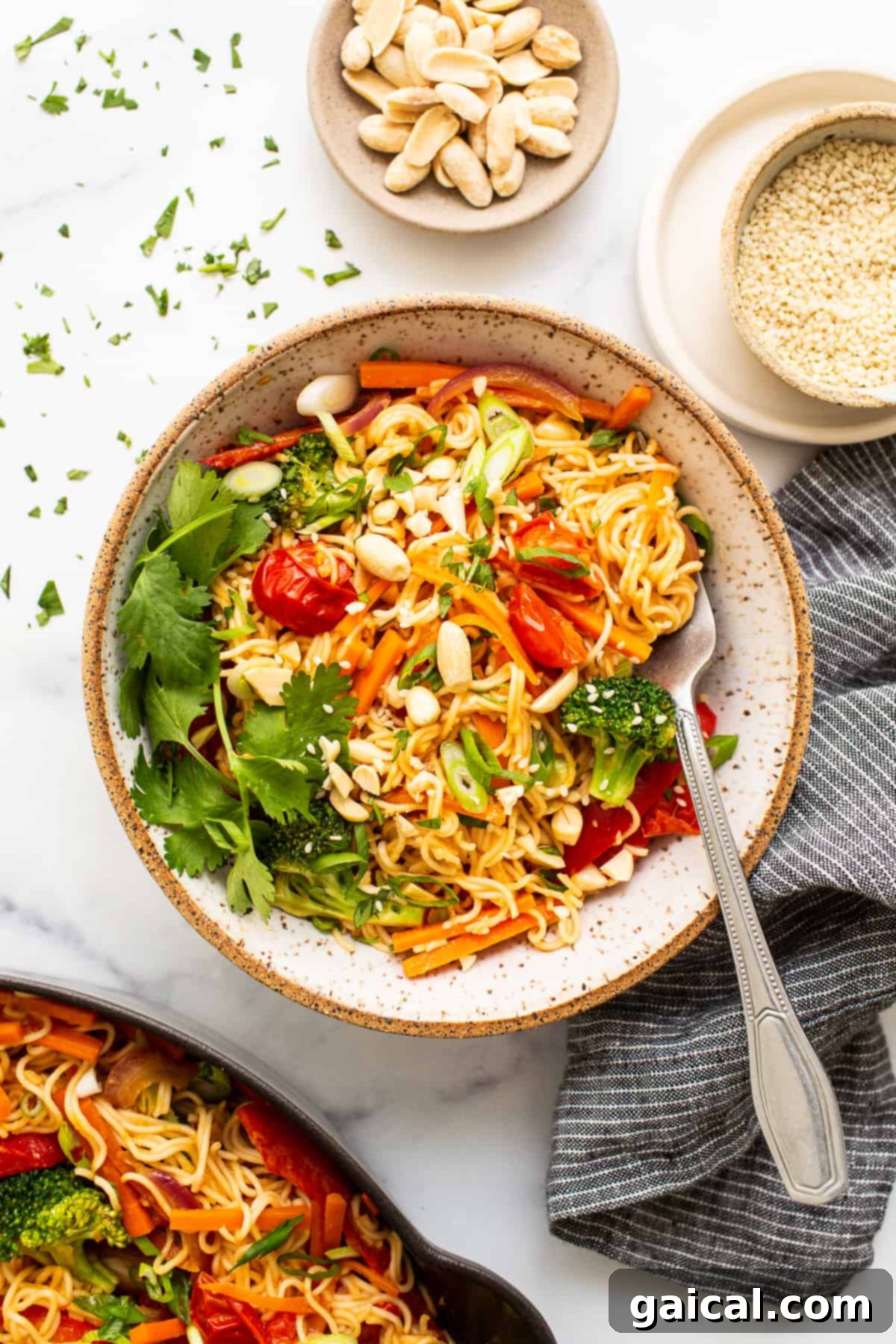 Peanut Butter Noodles with Fresh Veggies A bowl of vibrant peanut butter noodles with assorted vegetables, topped with fresh cilantro and crushed peanuts, perfect for a healthy meal.