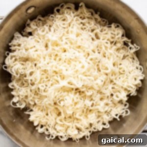 Cooked ramen noodles in a bowl, ready for the next step.