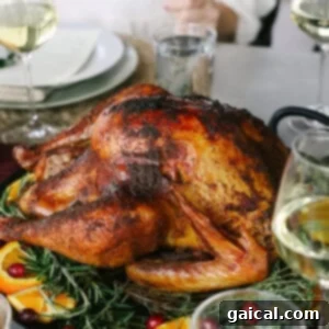 A perfectly smoked whole turkey on a platter, ready for carving.