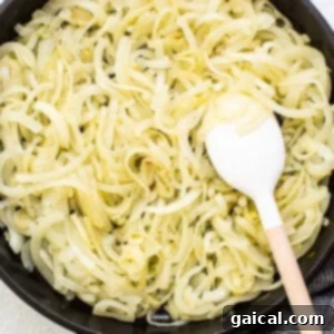 Effortless Caramelized Onions 9 Sliced onions being added to a skillet with olive oil, ready to begin the caramelization process.