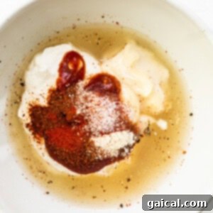 A bowl of burger sauce ingredients being mixed.