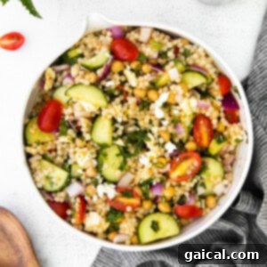 Vibrant Black Bean Couscous Medley 3 A colorful Mediterranean couscous salad in a bowl, featuring fresh vegetables, herbs, and feta cheese.